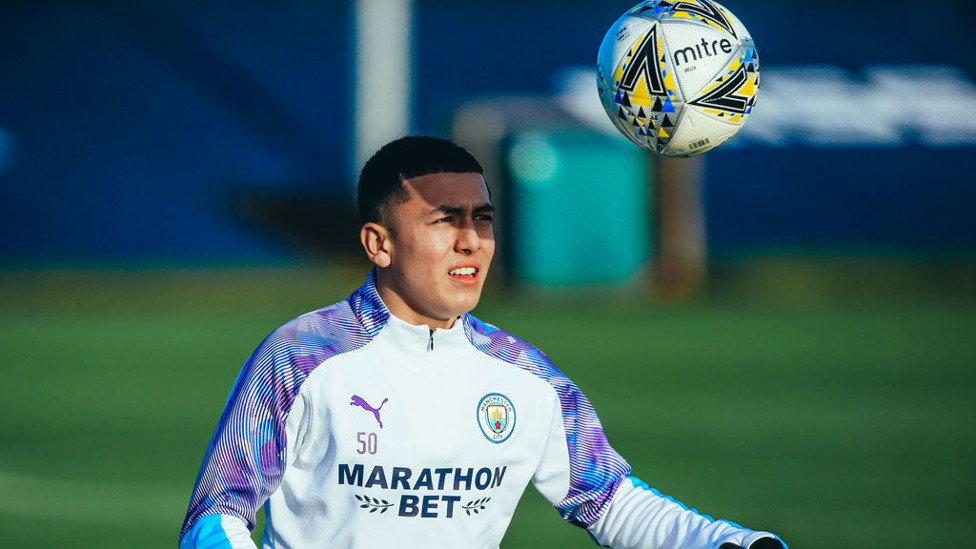 EYES ON THE PRIZE : Ian Carlo Poveda gets some shade from the ball.