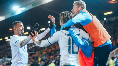 SUPER JACK: Grealish is mobbed after doubling City's lead.