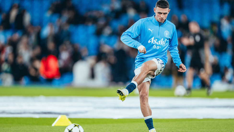 PHIL-ING GOOD : Foden gets in the mood during the pre-match warm up.