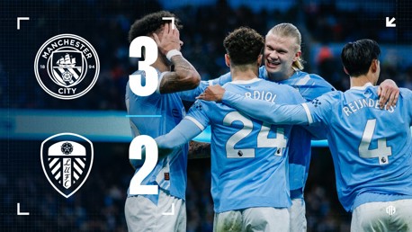 Manchester City defeated Leeds United with a 3-2 scoreline. The image shows Manchester City players celebrating the victory. The Manchester City and Leeds United logos are displayed, along with the final score.
