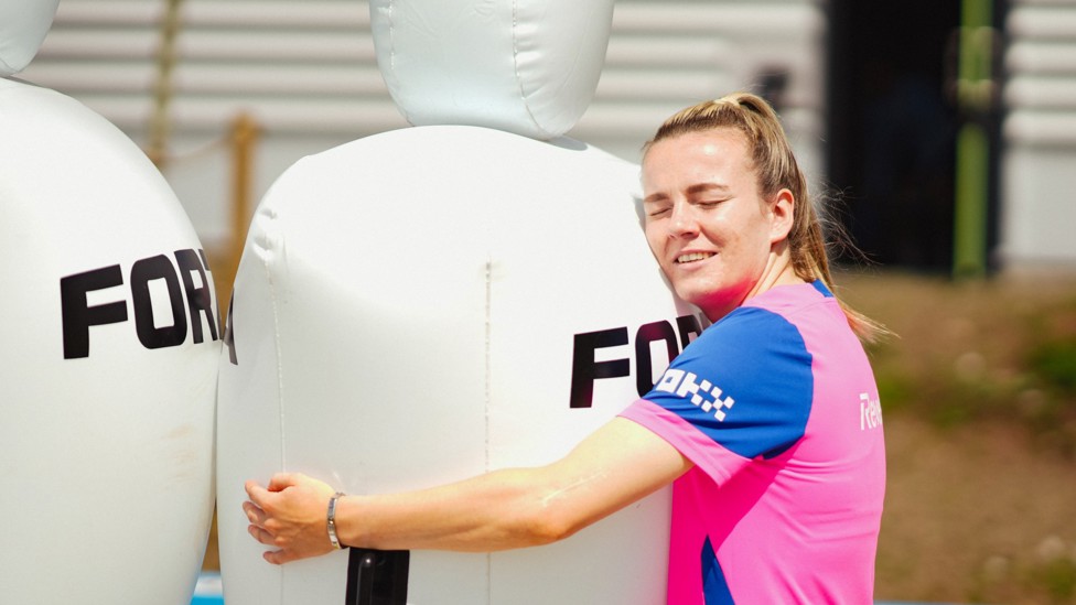MAKING FRIENDS : Lauren Hemp embraces one of the inflatable mannequins. 