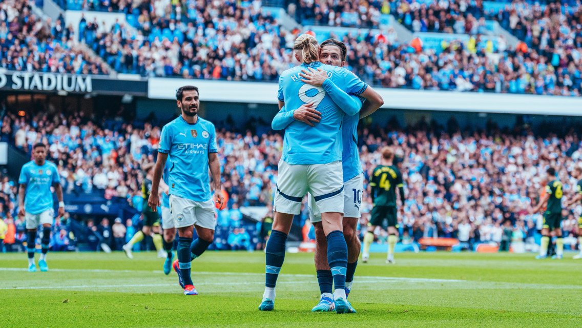 HAALAND HUGS: Our number nine feels the love after making it 2-1.