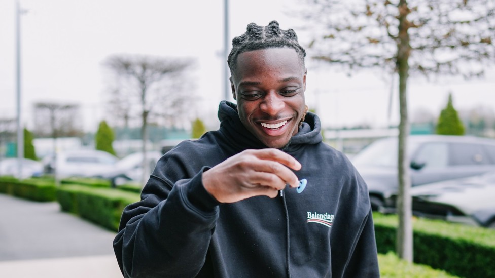 ALL SMILES : Jeremy Doku is clearly pleased with his likeness!