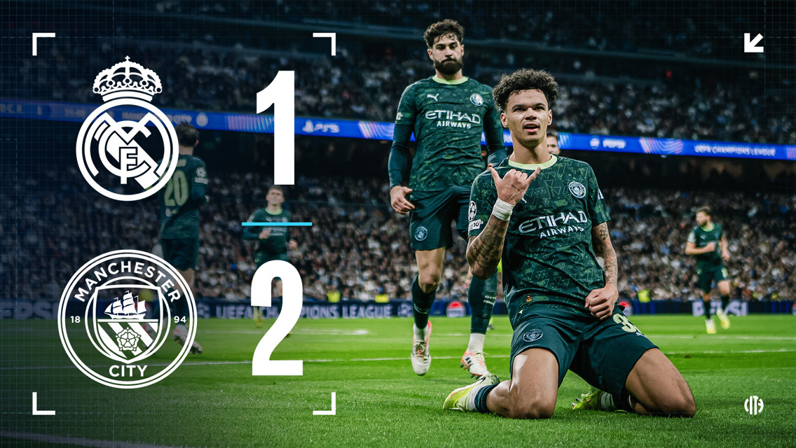 A football match image showing Manchester City's goal celebration against Real Madrid. Manchester City players in green jerseys celebrate after scoring, with score displayed: Real Madrid 1, Manchester City 2.
