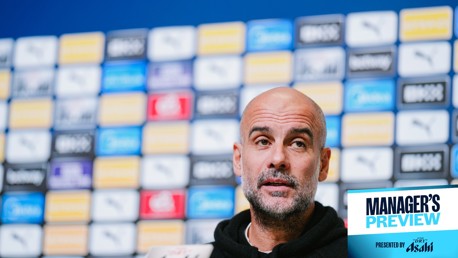 A person with a blurred face is in front of a backdrop filled with sponsor logos. The image has 'MANAGER'S PREVIEW' text displayed on the lower right corner, presented by Asahi.