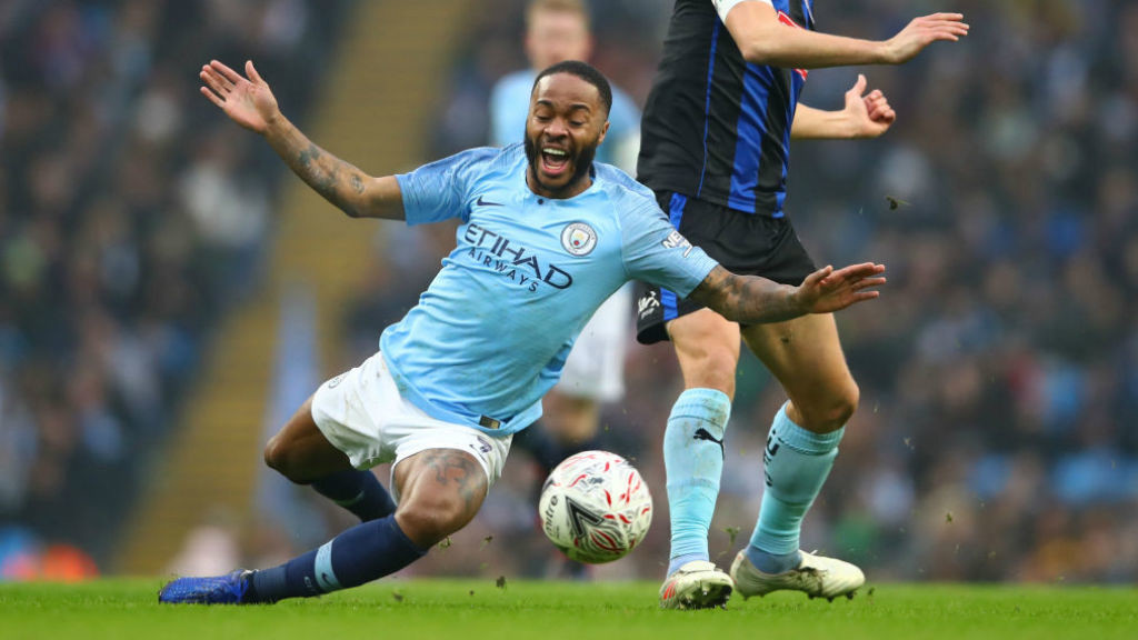 CRASH LANDING : Raheem Sterling is felled after a Rotherham challenge