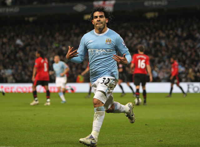 Carlos Tevez celebrates scoring in the Manchester Derby