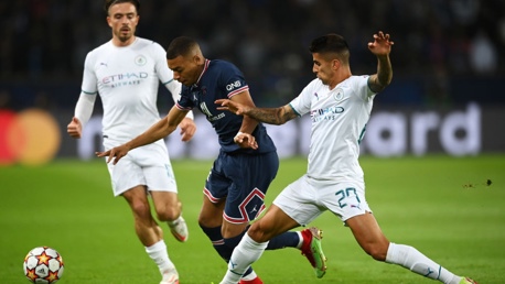 BATTLE: Cancelo gets a foot in on Mbappe.