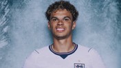 A person wearing an England football jersey with a blurred face on a textured blue-grey background.