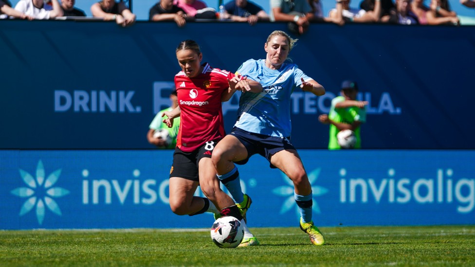MIDFIELD BATTLE  : Coombs in the thick of the action. 