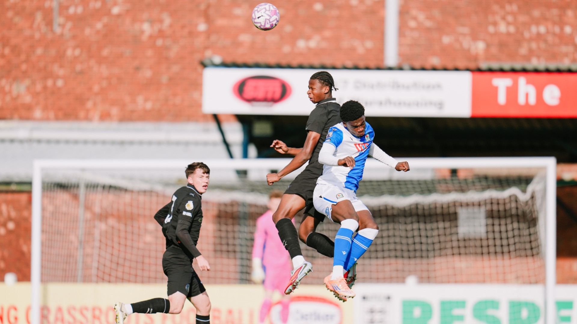 UP AND AT 'EM: Stephen Mfuni rises high to a header.