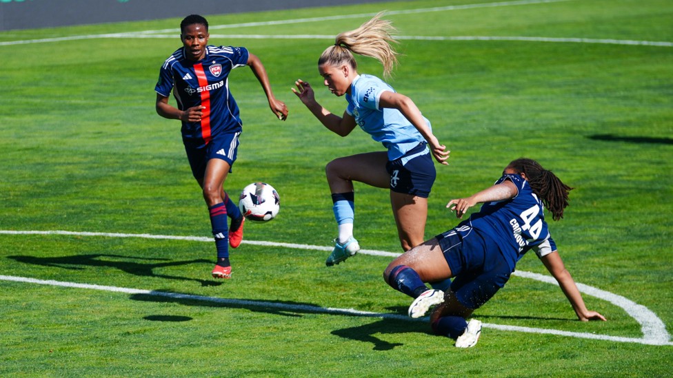 FLICK : Poppy Pritchard takes on a defender.