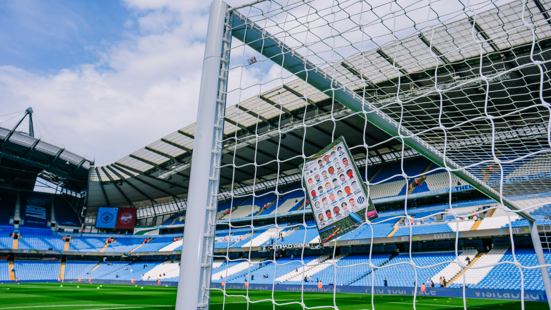 Goal net with a lineup sheet attached at an empty Etihad Stadium.