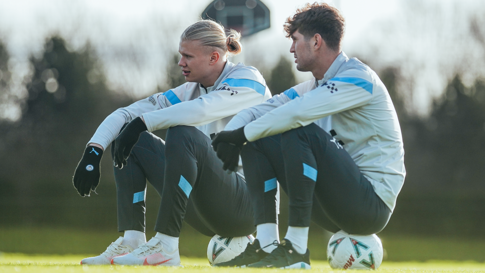 TAKE A SEAT : Haaland and Stones have a moment to relax