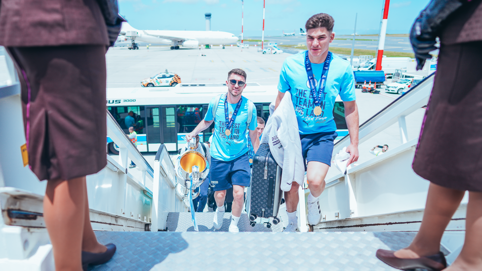 HAND LUGGAGE  : Aymeric Laporte makes sure the prestigious trophy makes it onto the plane. 