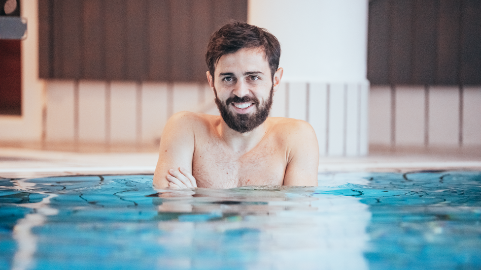CHILLY : Bernardo Silva feeling the cold as he enters the pool 
