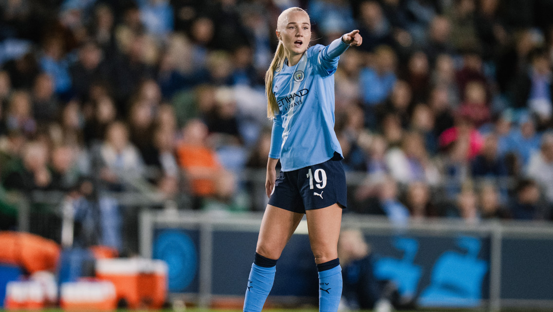 A Manchester City player wearing jersey number 19 is gesturing and pointing during a match.