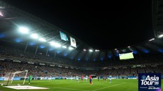 Football match between two teams at a stadium during night time, featuring Manchester City and Atletico Madrid banners. Large crowd in attendance. Part of Asia Tour 2026 presented by experience Abu Dhabi.