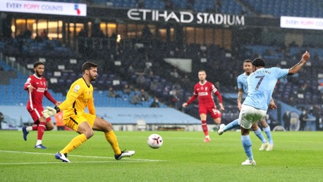 CAUSING A STER: Raheem's goal-bound effort is well blocked by Alisson