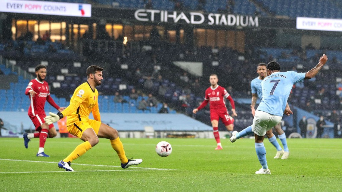 CAUSING A STER: Raheem's goal-bound effort is well blocked by Alisson