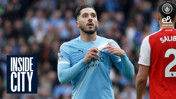 A Manchester City player in a light blue kit adjusts his shirt with a blurred face. Arsenal player in a red and white kit visible. Text reads 'INSIDE CITY'.