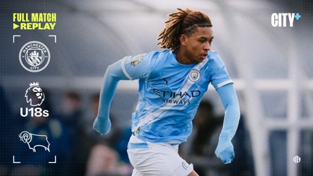 Player from Manchester City U18s on the pitch during a match against Derby County, with CITY+ branding and logos visible.