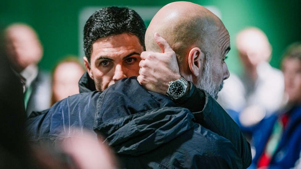 BOSSES : Pep and Arteta share a hug in the tunnel.
