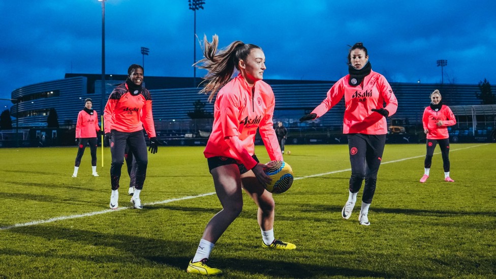 GET MOVING : Annie Hutchings grabs the ball as the players start a warm up game