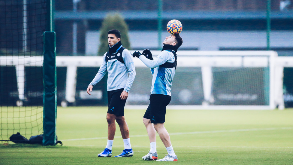Ball to head - Aymeric balances while Rodrigo looks on