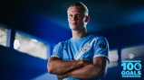 Blurred-face man in Manchester City jersey stands proudly with arms crossed in front of 'Erling Haaland 100 Goals 2022/23-Present' graphic.