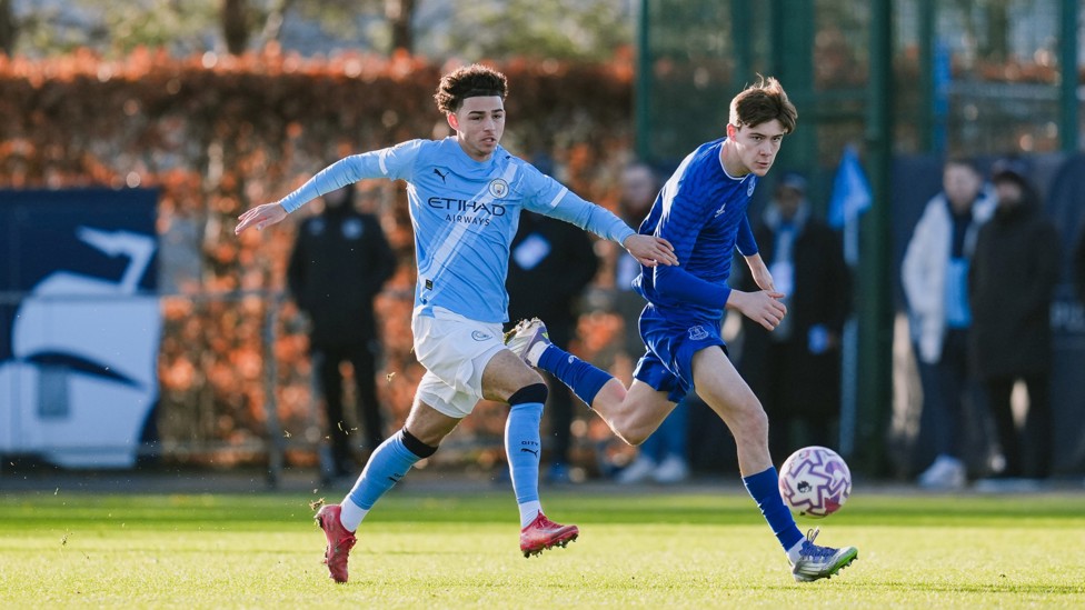 LEADING THE LINE : Kylan Midwood puts pressure on Everton's defence.