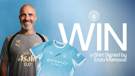 A Manchester City competition graphic featuring a person in a training kit with initials 'EM' and a shirt signed by Enzo Maresca. The text promotes winning the signed shirt.