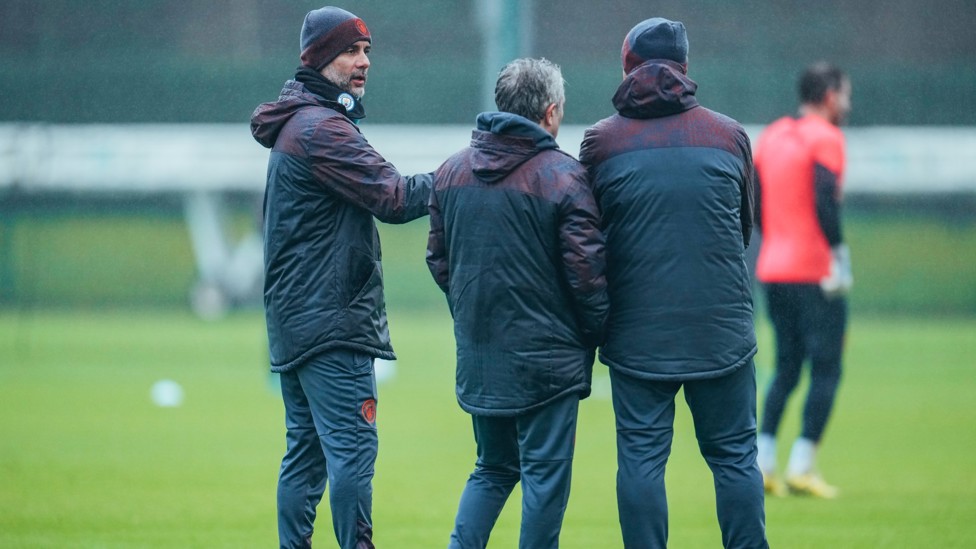 MEETING OF THE MINDS : Pep Guardiola and his coaching staff in discussion.