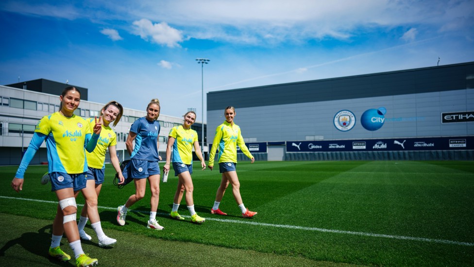 ALL SMILES : The players make their way out onto the pitch alongside Club legend and coach Steph Houghton