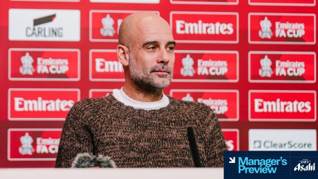 A person is at a press conference with an FA Cup-themed backdrop featuring various logos and the text 'Manager's Preview' and 'Asahi Super Dry'.