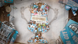 Collage of Manchester City Women's 2026 Adobe FA Cup victory featuring players in light blue kits surrounded by memorabilia including medals, scarves, and the trophy.