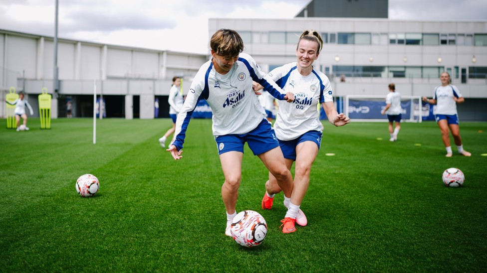 Aoba Fujino and Lauren Hemp fight for the ball....