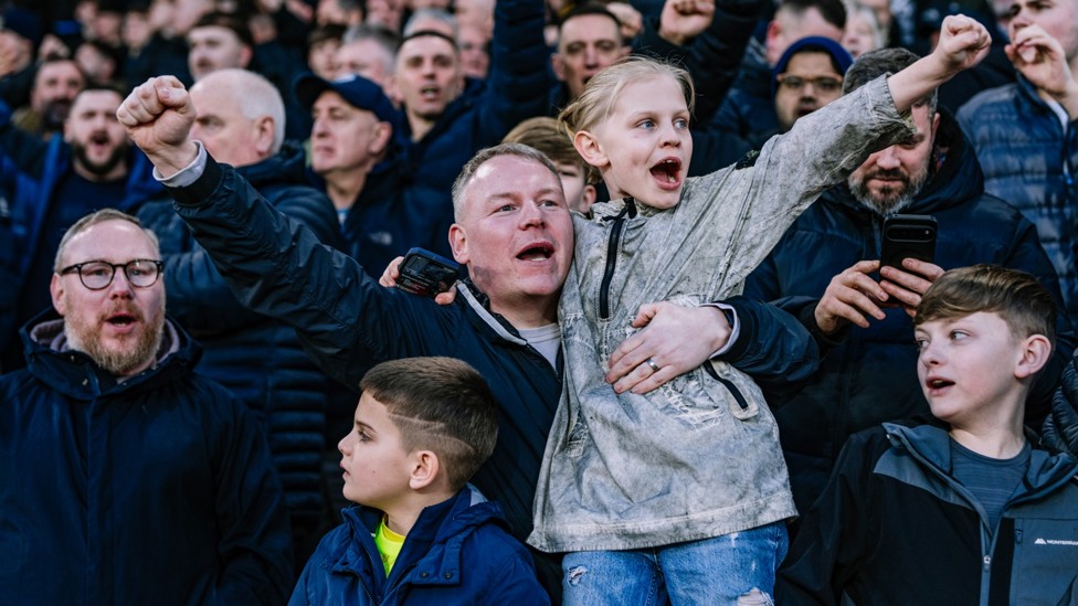 ONE FAMILY: A young fan supporting from the away end