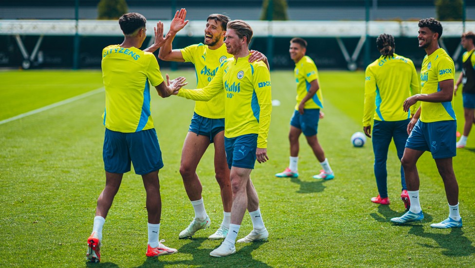HIGH FIVES: Ruben Dias and KDB look impressed by something Vitor Reis has done...
