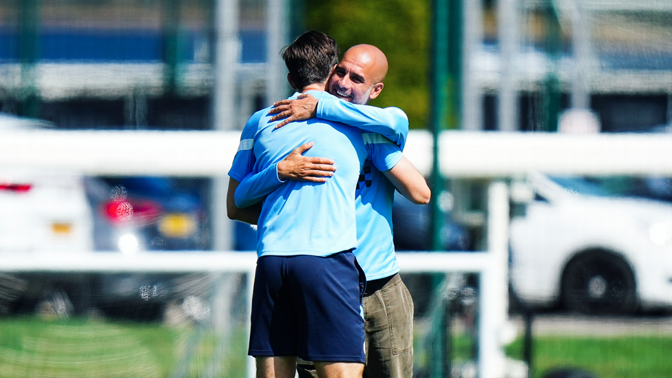 BOSSING IT : Gareth Taylor and Pep Guardiola embrace ahead of the session