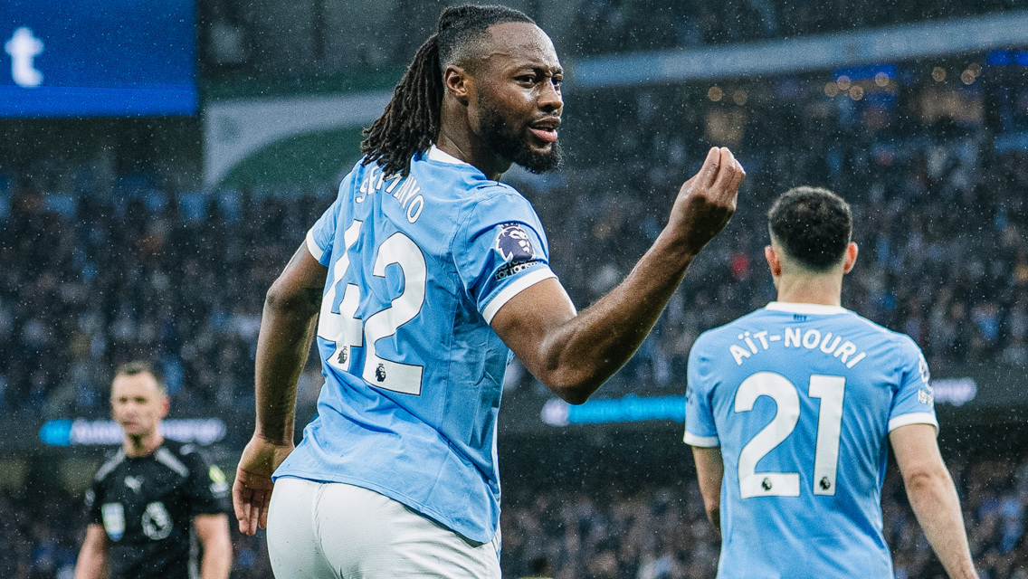 Football players in light blue Manchester City uniforms on the field during a match, with visible last names Semenyo and Aït-Nouri on their jerseys.