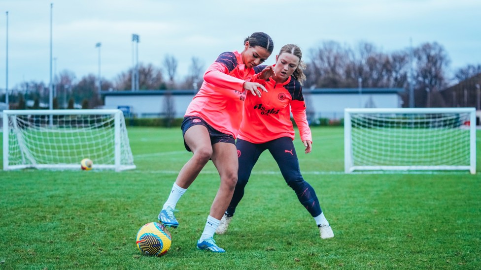 MIDFIELD BATTLE : Lois Marley-Paraskevas and Ruby Mace tussle for the ball.
