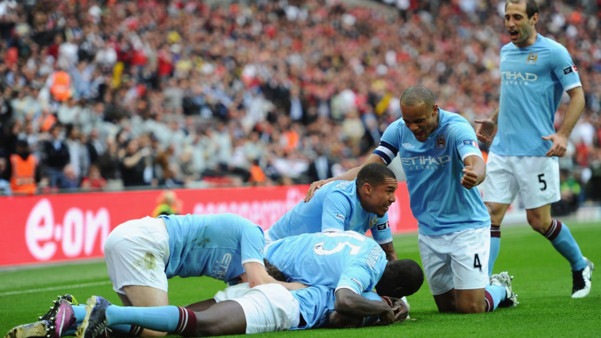 BLUE HEAVEN: Yaya is engulfed by his joyous team mates.
