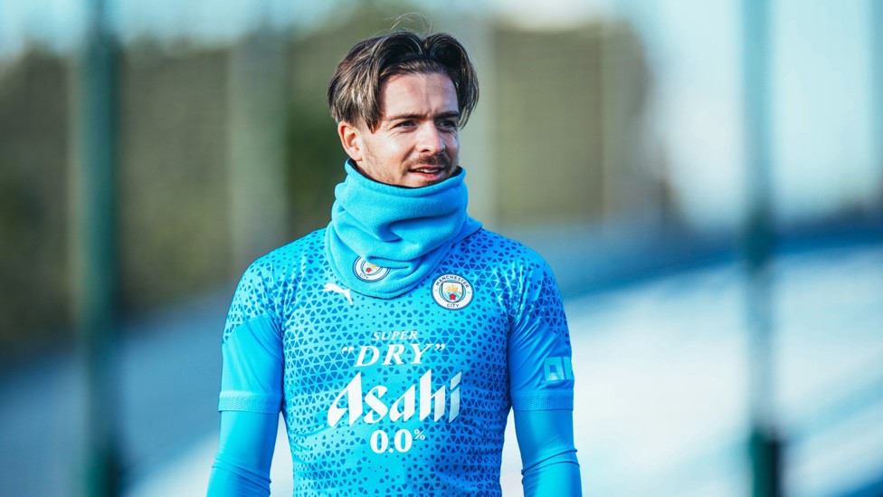 WRAPPED UP : Jack Grealish protects himself from the elements