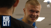 A person smiling in a room with the Manchester City logo and text 'INSIDE CITY' visible. The image also features the Etisalat and e& logos.
