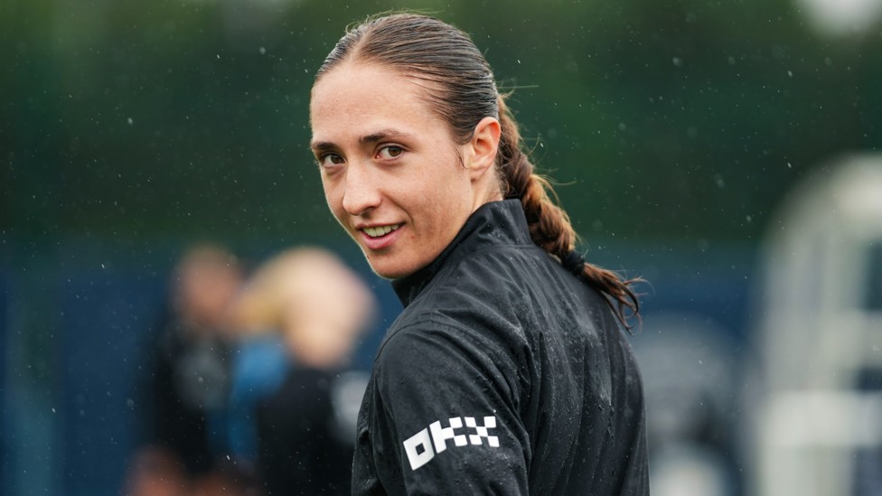 CHEESING: Naomi Layzell holds a smile through the downpour