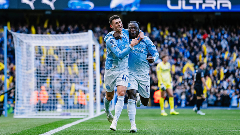 SCORER AND PROVIDER : Foden and Doku celebrate.