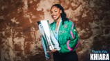 A person smiling while holding a large trophy, wearing a Manchester City jacket. The words 'Thank You Khiara' are seen on the image.