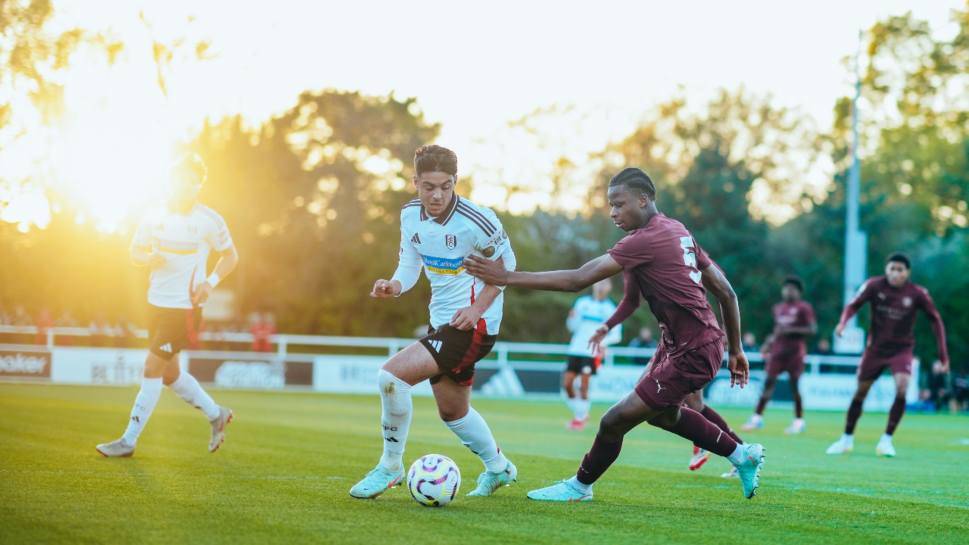 SUNNY SCENERY : Stephen Mfuni looks to regain possession.