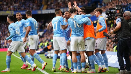 SQUAD GOALS: The starting players and the subs all come together to celebrate the goal.